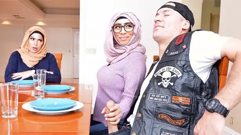 Hijab-wearing nymph providing a hand-job from under the table