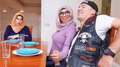 Hijab-wearing nymph giving a hand-job from under the table